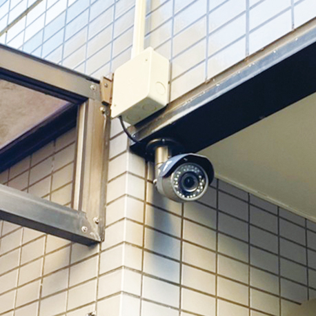 マンションの入り口を監視する防犯カメラ